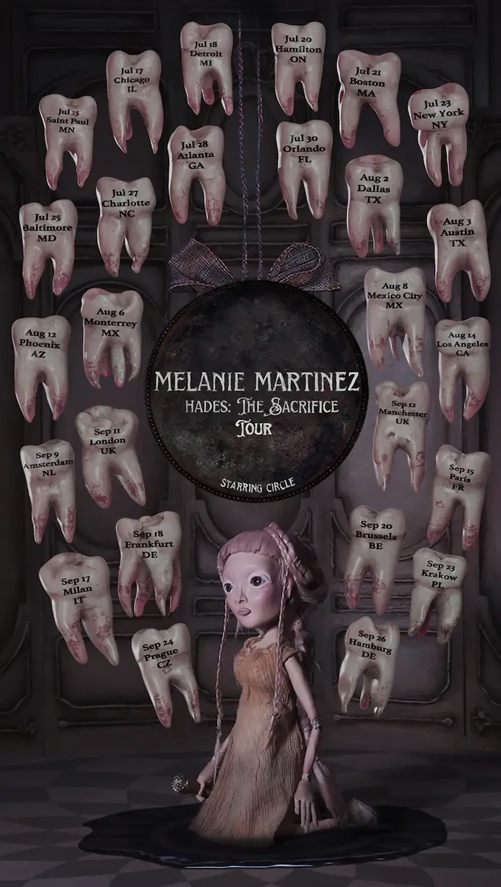 A doll-like figure kneels on a black puddle. Hanging teeth display tour dates for Melanie Martinez's "Hades: The Sacrifice Tour." Dark setting.